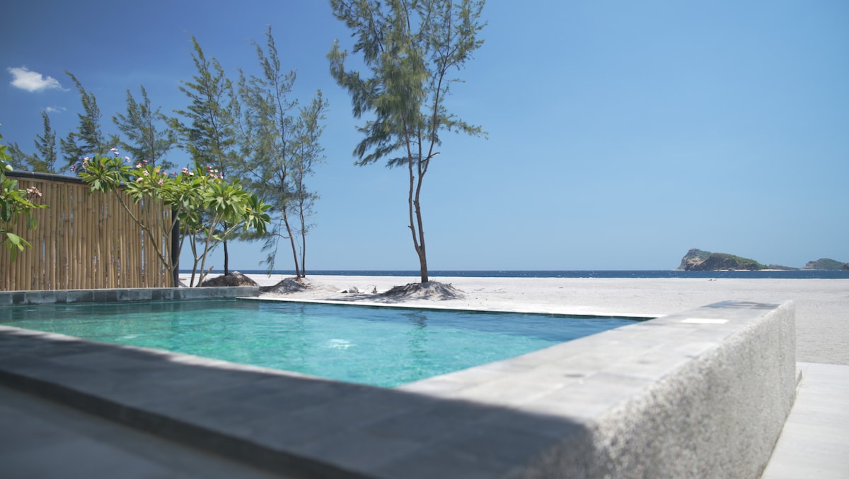 Private infinity pool overlooking beach and ocean with island view