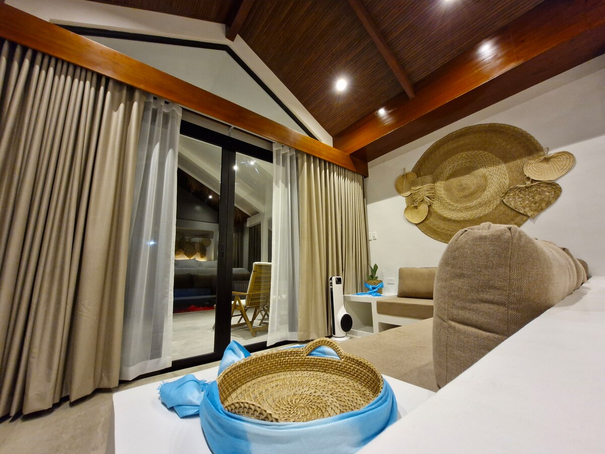Villa bedroom interior at night with rattan wall decor and sliding glass doors
